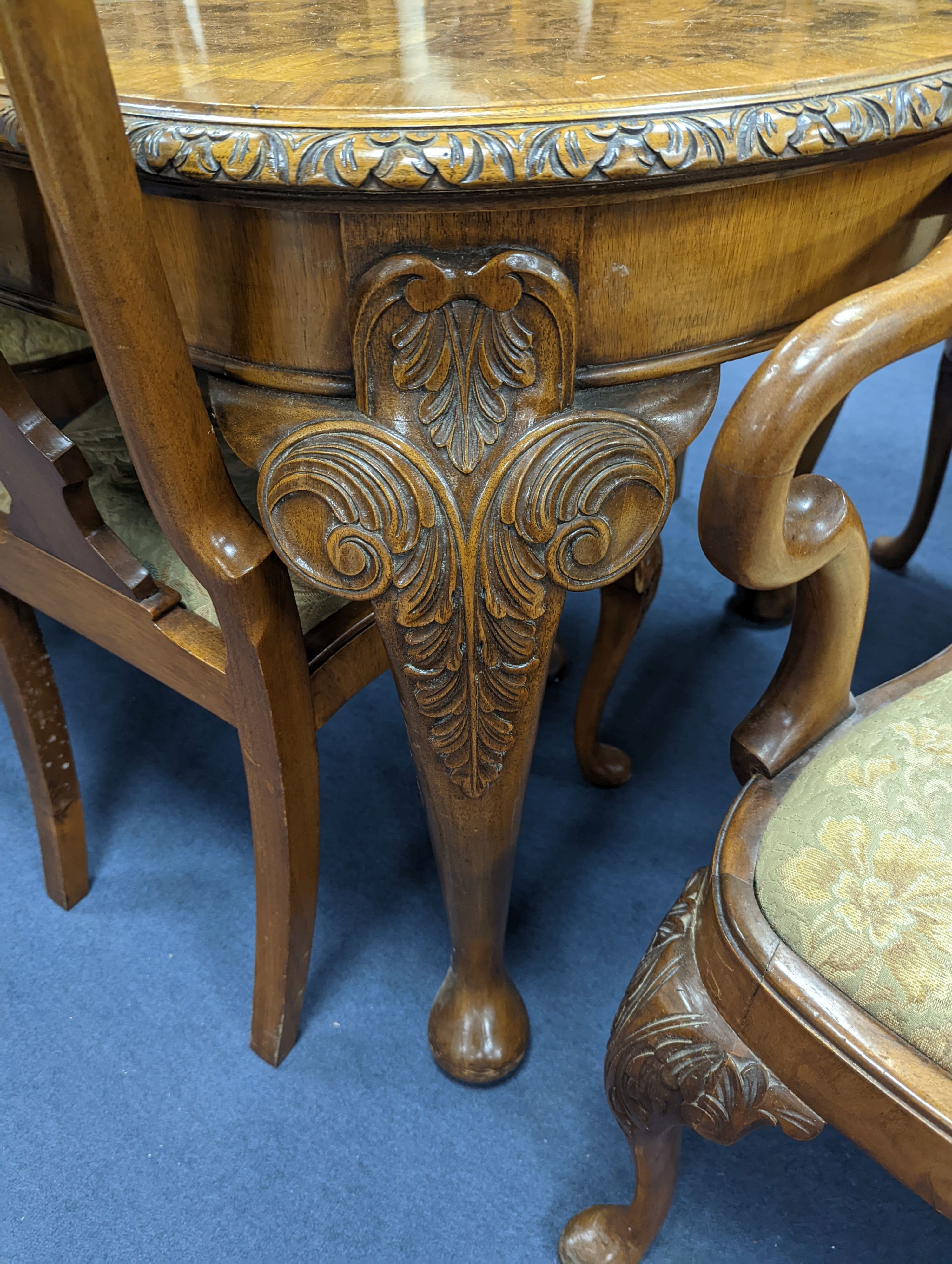 A Queen Anne revival burr walnut dining suite, comprising serpentine sideboard, length 168cm, depth 56cm, height 98cm, extending dining table, 210cm extended, one spare leaf, width 90cm, height 75cm and eight chairs, two